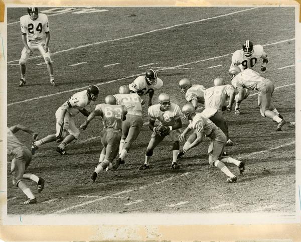 Football game action, ca. 1960s