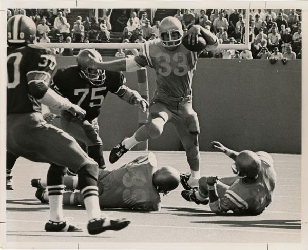 UCLA running back Randy Tyler running a play during a game