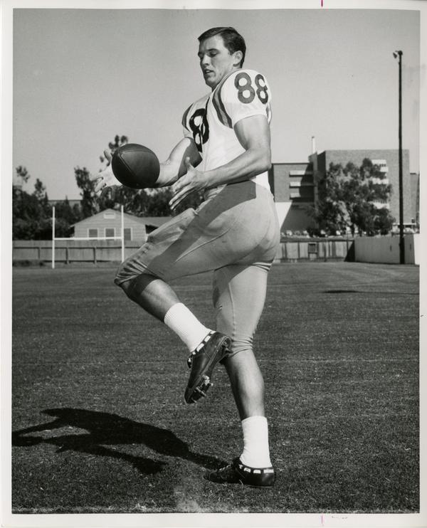 UCLA right end Dick Witcher catching a ball in practice, 1964