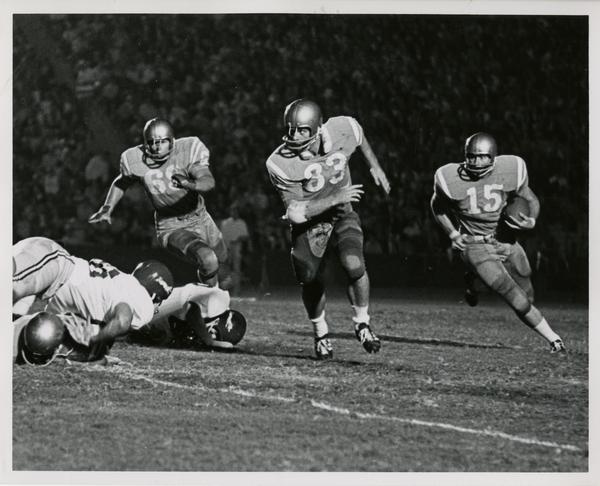 Quarterback Jim Nader running a sweep downfield during a football game