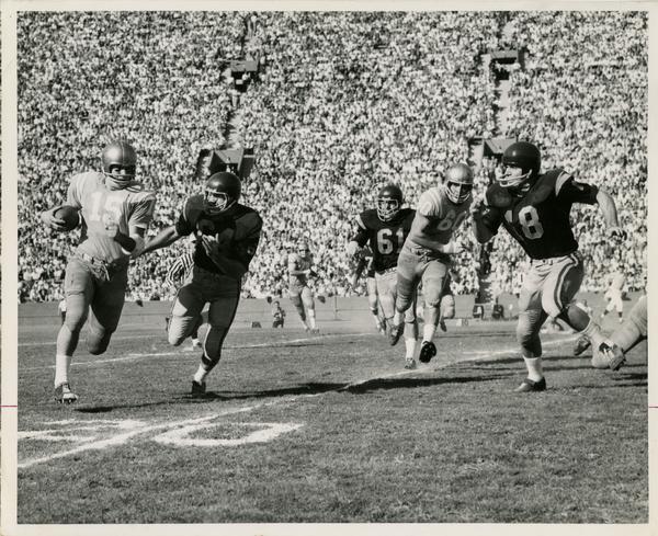 UCLA quarterback Larry Zeno running for open ground during a football game