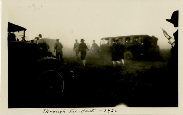 Dedication attendees walking through the dust caused by cars arriving to the dedication area, October 1926