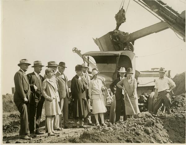 Woman with shovel breaks ground at new campus groundbreaking ceremony, October 1926