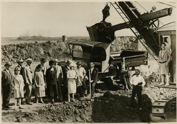 Man posing with shovel has fake face superimposed over his at new campus groundbreaking ceremony, October 1926