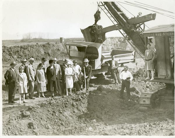Man posing with shovel at new campus groundbreaking ceremony, October 1926