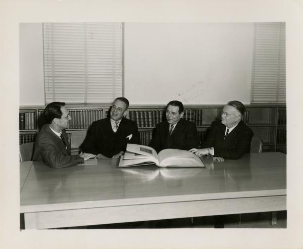 Fred B. Adams, Maye Ewing, Dave Randall and WW Robinson seated at table