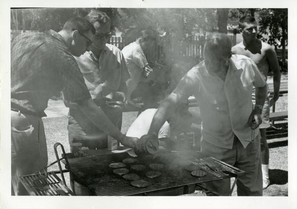 Richard Logan, Herb Eder, Peter Fielding, and Bob Lee grilling at a geography department picnic