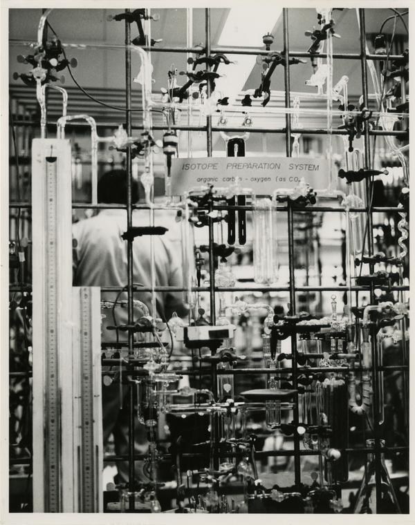 Isotope Preparation System in the Geophysics Department laboratory with a worker in the background