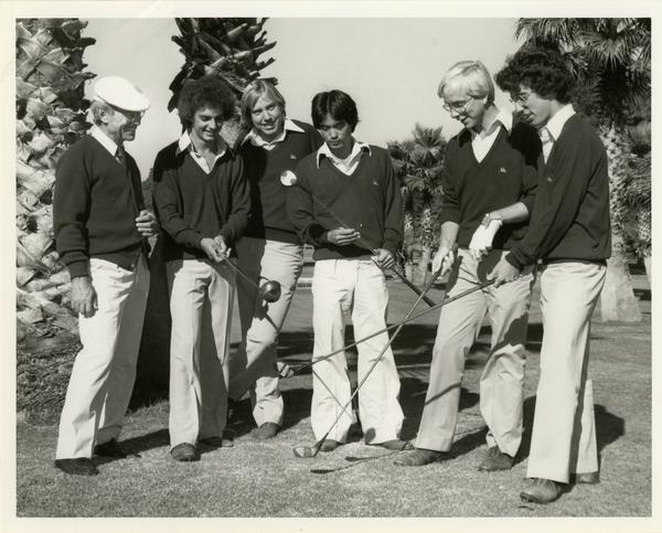 Members of the Golf Team with golf clubs on the field, ca. 1980's
