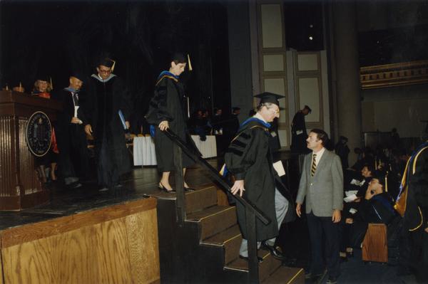 Faculty walk down from the stage during PhD Hooding Ceremony, June 1988