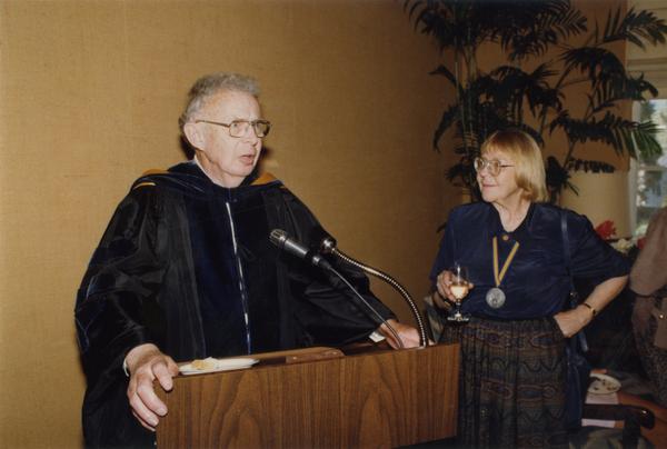 Raymond Fisher speaks at podium with Victoria Fromkin at his side during Robing Reception, June 1988