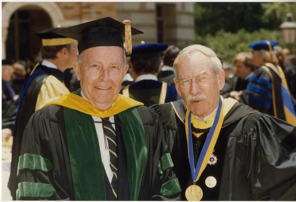 Franklin Murphy and Robert Vosper stand outside Royce Hall after PhD Hooding Ceremony, June 1988
