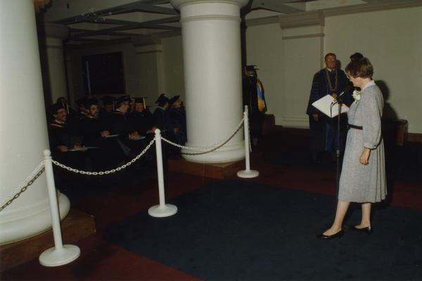 Beverly Liss reads out instructions for faculty march before PhD Hooding Ceremony, June 1988