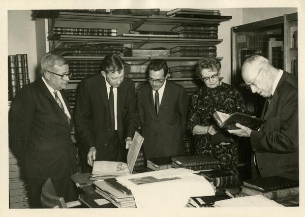 Chancellor F. D. Murphy Dr. Bennett Allen, and Mrs. Boris Krichesky viewing the gift collection of medical history books given to the Biomedical Library