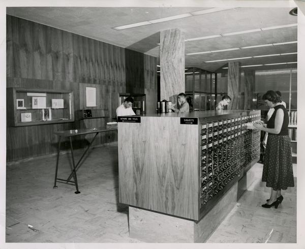 Students searching in Biomedical Library card catalog