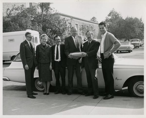 Ernest Moore, Esther Euler, John E. Smith, Whelon Voigt, and Robert Vosper at arrival of the intercampus shuttle, ca. january 1951