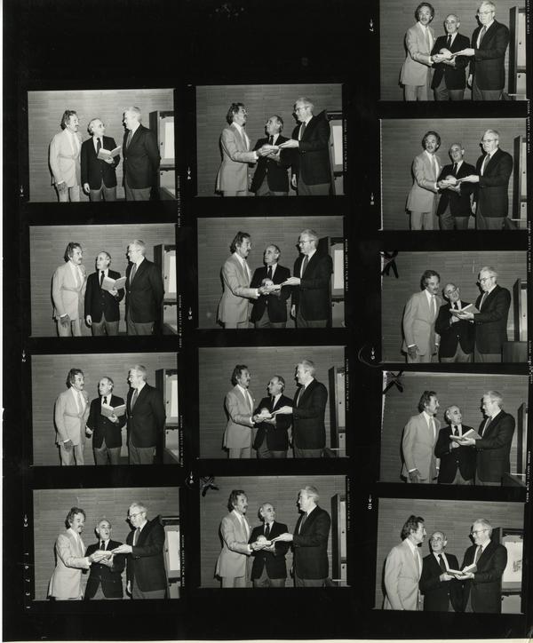 contact sheet of Robert Eckert, Russell Shank, and David Rodes looking at the five millionth volume, May 21, 1983