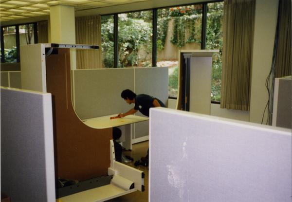 Worker builds cubicles for Library Special Collections renovation