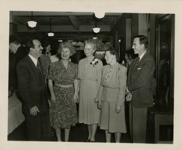 Library staff photo with Lawrence Clark Powell, Mrs Bryan, James Coldren Goodwin, Miss Hamiston, and Robert Vosper at Fanny Coldren retirement party, ca. 1946