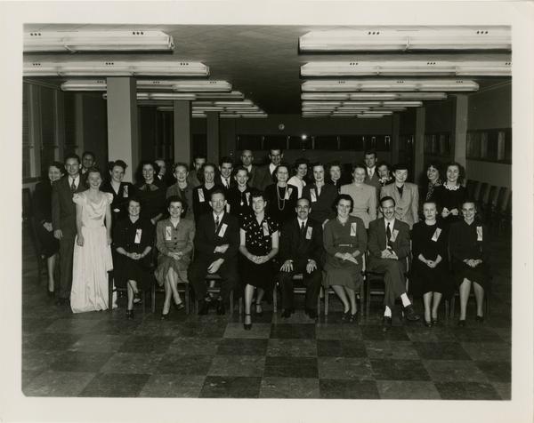 Library staff group portrait with Lawrence Clark Powell seated in center of front row
