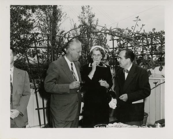 Lawrence Clark Powell with guests at party