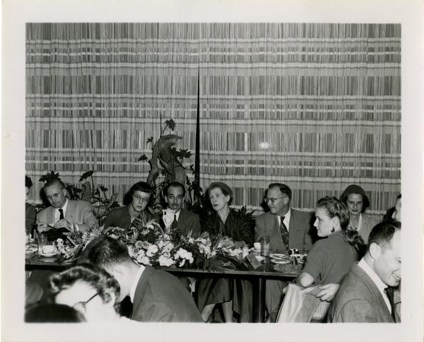 Page Ackerman, Lawrence Clark Powell, Mrs. Elmer Belt, and Chancellor Allen at Library staff Christmas party, December 19, 1957