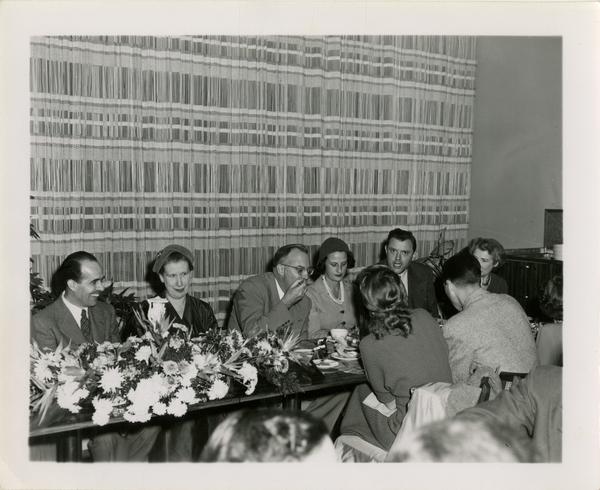 Lawrence Clark Powell, Mrs. Elmer Belt, Chancellor Allen and other staff at Library staff Christmas party, December 19, 1957