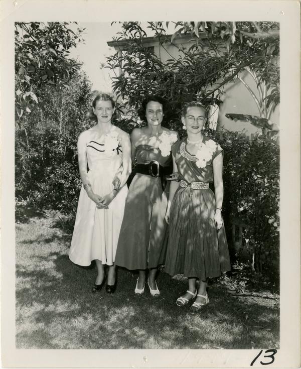 Fay Powell poses with two guests at Library staff party