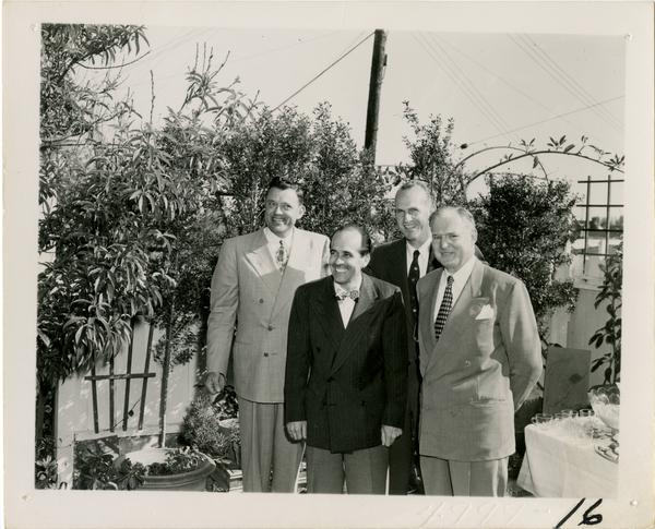 Paul Dodd, Lawrence Clark Powell, Harold Hamill, and John Henderson at Library staff party