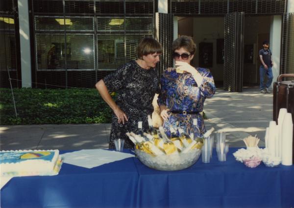 Library staff members enjoying refreshments at retirees party, ca. 1991