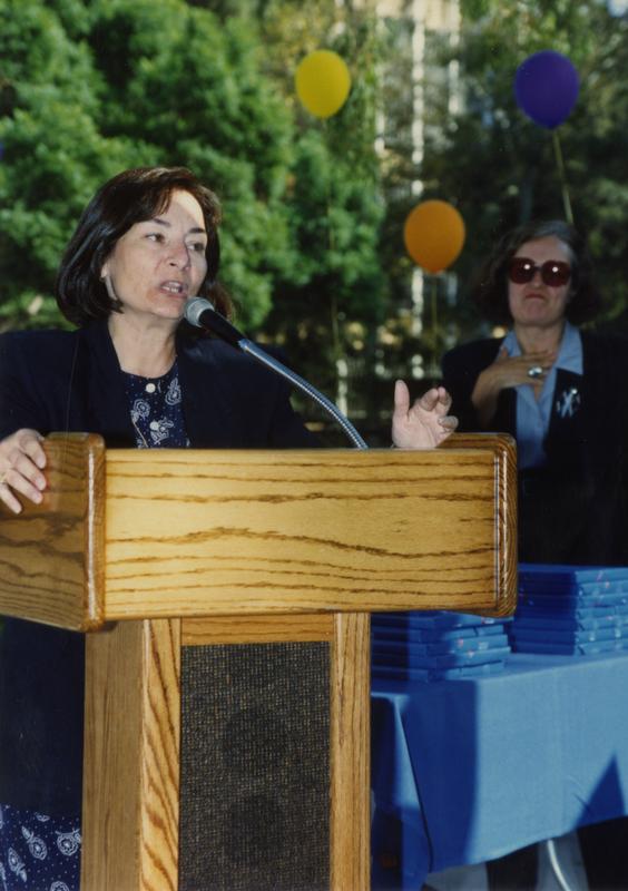 Library staff member speaking at retirees party, ca. 1991