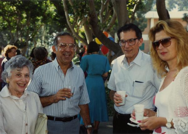 Library staff members smile for the camera at a staff event, ca. 1991