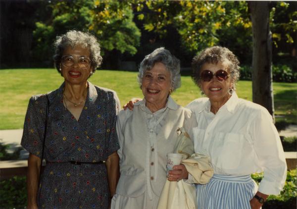 Three library staff members pose for a photograph, ca. 1991