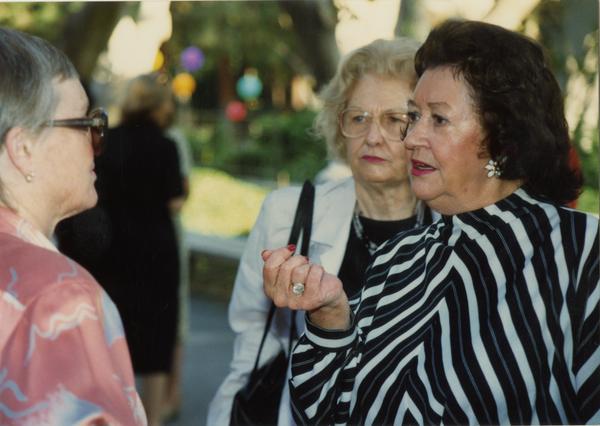 Library staff members talk with each other at a staff retirement party, 1991