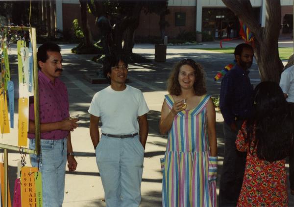 Various library staff members standing around at a staff retirement party, 1991