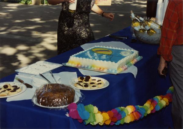 Decorated table covered with various desserts at a staff retirement party, ca. 1991