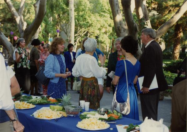 Crowds at the library staff retirement party and food tables, 1991