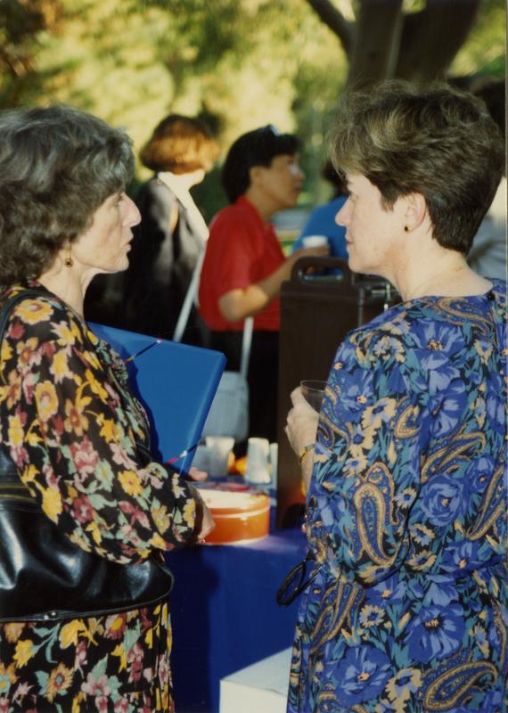 Library staff talk to each other at a staff retirement party, 1991