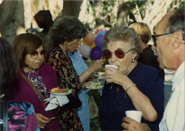 Library staff members eat at the staff retirement party, 1991