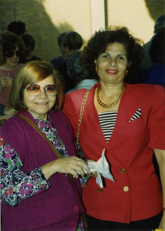 Two female library staff workers pose for a photograph at the staff retirement party, 1991