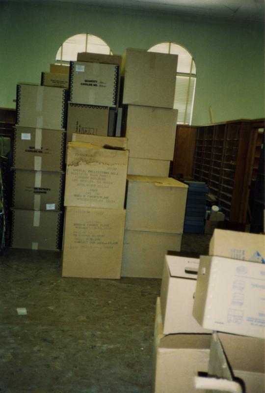 Stacked boxes in room 390, Powell Library, ca. 1990's