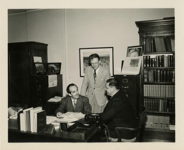 Lawrence Clark Powell talks with other faculty members of the School of Library Service