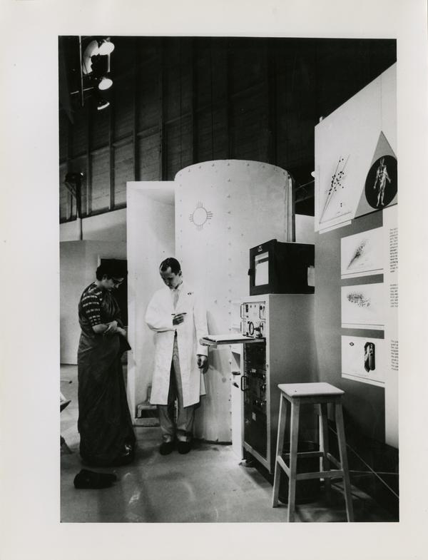 Scientists at the Los Alamos Scientific Laboratory standing next to equipment