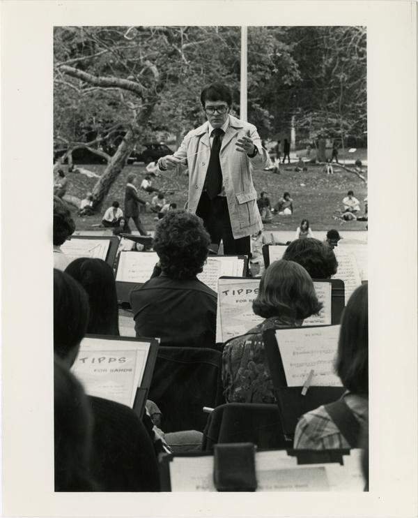 View of conductor during musical performance outdoors