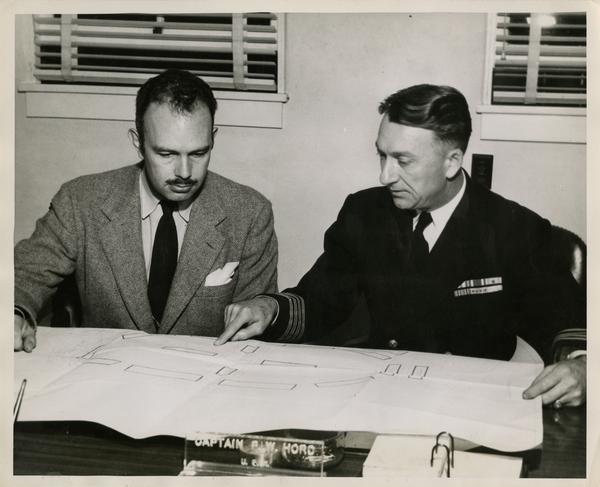 Dr. Franz N.D. Kurie discussing plans with Captain P.W. Hord in Navy Electronics Laboratory