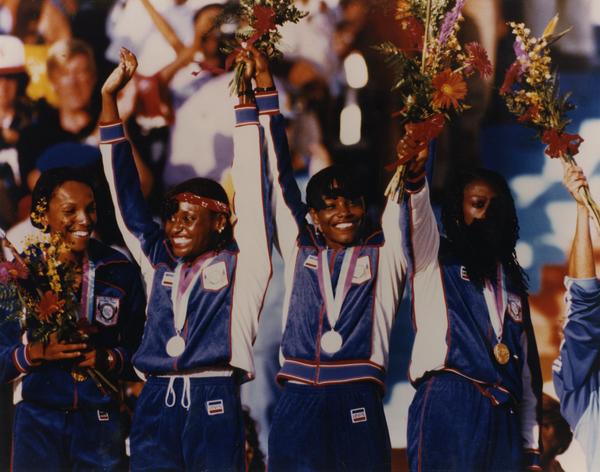 Sherrie Howard (second left) & other members of gold medal 1600-meter women's relay team on the Victory Stand.