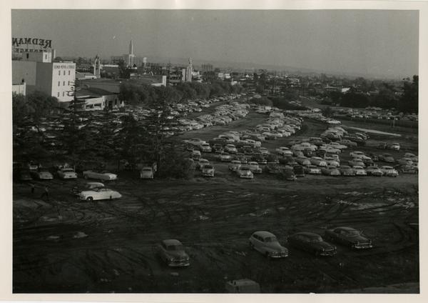 Cars parked on a dirt lot