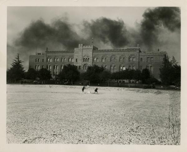 People playing in snow in front of Kinsey Hall, January 11, 1949