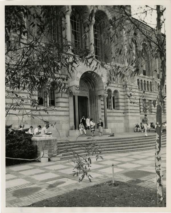 Students standing outside of Powell Library entrance