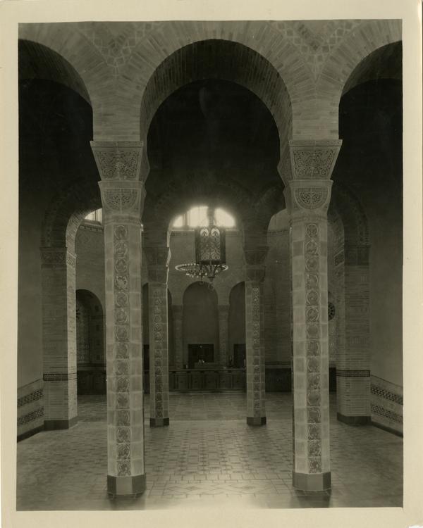 Interior view of Powell Library loan desk behind arches, ca. 1929